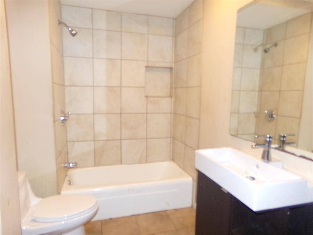 211 S Alexander Avenue, Duncanville, TX 75116 Wall-mounted vanity with a rectangular basin sink, chrome faucet, and integrated mirror
