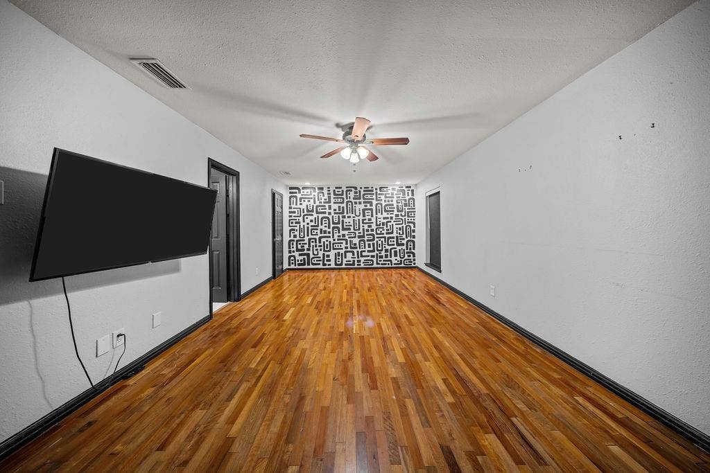 9302 Chimney Sweep Lane, Dallas, TX 75243 Wood-finish flooring with a ceiling fan and recessed lighting