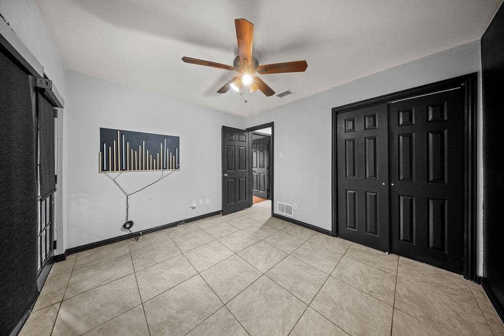 9302 Chimney Sweep Lane, Dallas, TX 75243 Neutral wall tones complemented by dark trim and doors