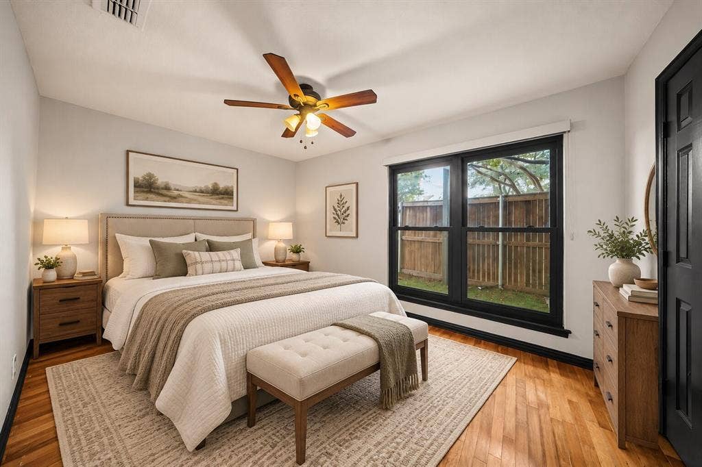 9302 Chimney Sweep Lane, Dallas, TX 75243 Hardwood flooring, painted walls, ceiling fan, and large window overlooking the backyard
