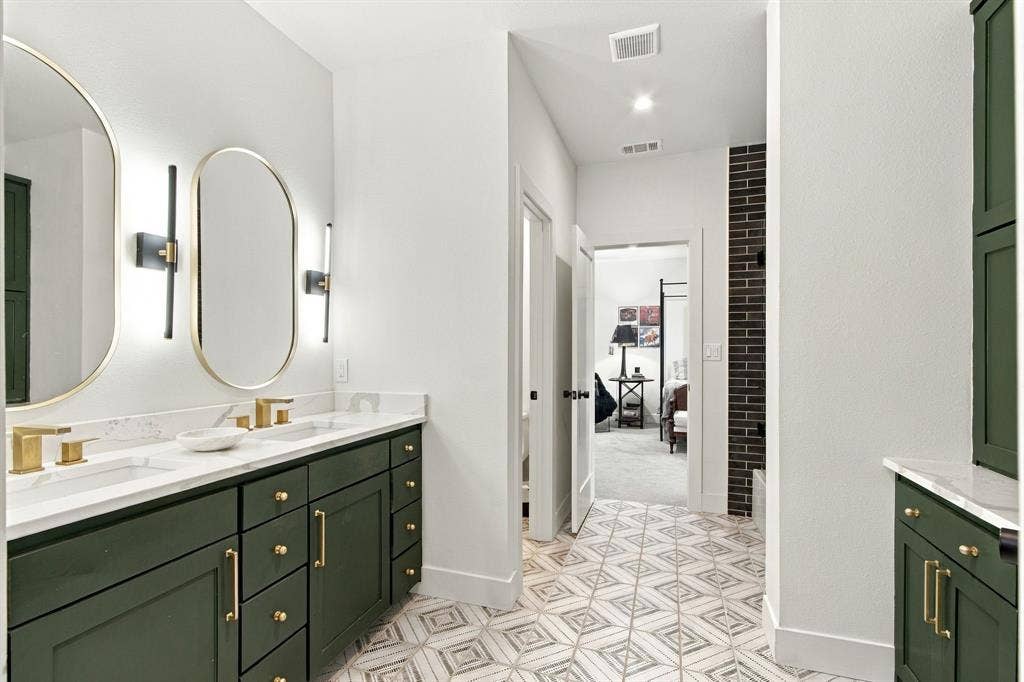 46 Crown Place, Richardson, TX 75080 Dual vanity with green cabinetry and gold-tone hardware