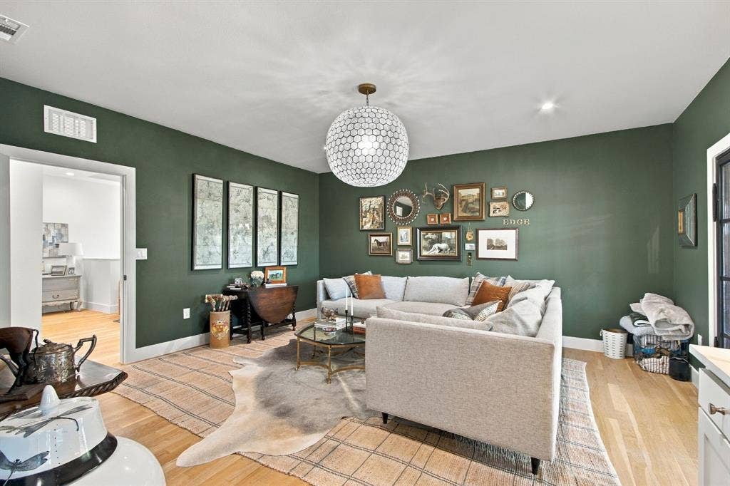 46 Crown Place, Richardson, TX 75080 Light wood-finish flooring, recessed lighting, and a modern ceiling fixture illuminate this space with green walls