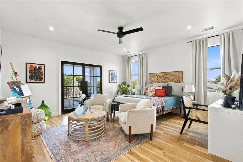 46 Crown Place, Richardson, TX 75080 Wood-finish flooring, recessed lighting, and a black ceiling fan illuminate this bright space