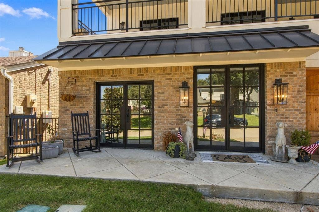 46 Crown Place, Richardson, TX 75080 Brick exterior with black-framed double doors, a metal awning, and integrated outdoor lighting