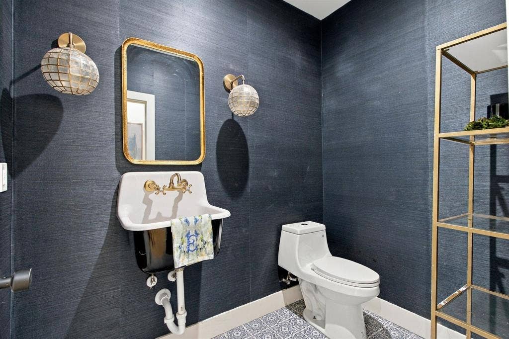 46 Crown Place, Richardson, TX 75080 Textured wall covering, decorative floor tile, wall-mounted sink, gold-framed mirror, and gold-finish shelving