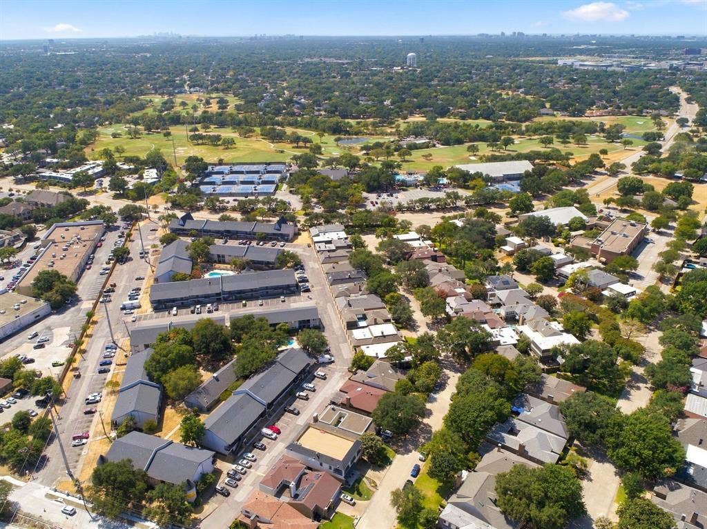 46 Crown Place, Richardson, TX 75080 Aerial perspective featuring a residential area with varied rooflines and extensive tree canopy