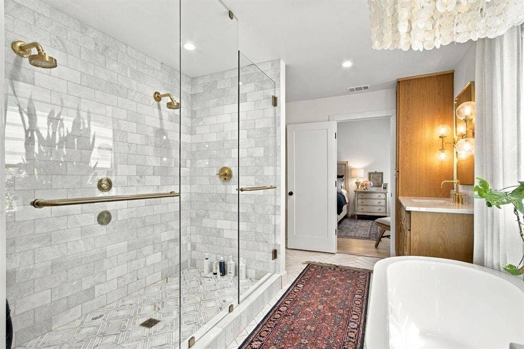 46 Crown Place, Richardson, TX 75080 Glass-enclosed shower with subway tile surround and brass fixtures