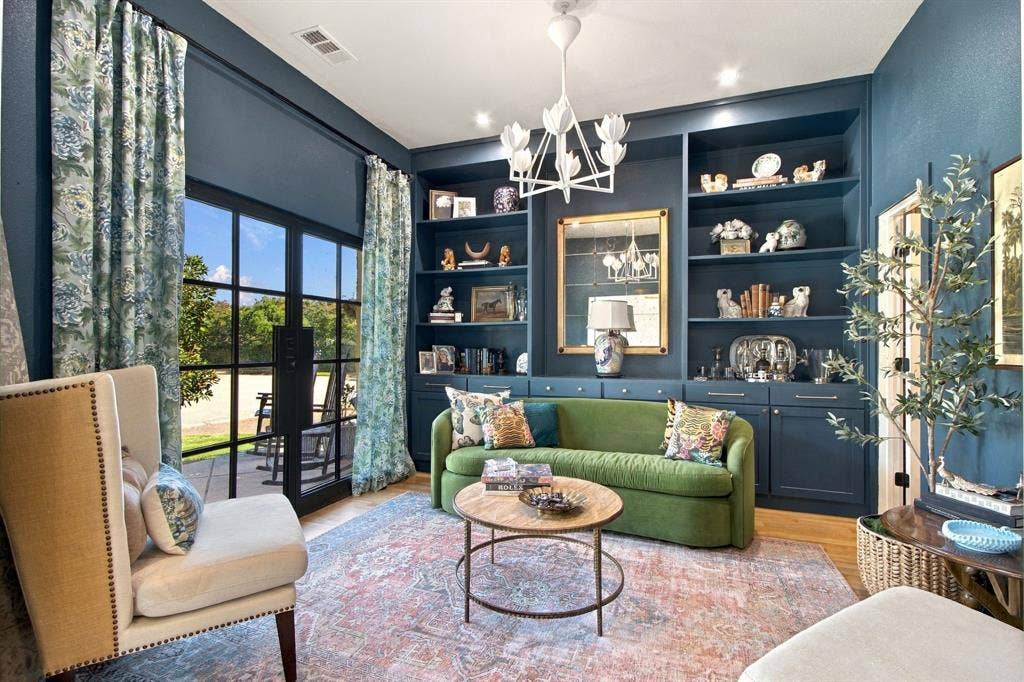 46 Crown Place, Richardson, TX 75080 Custom built-in shelving, glass-panel French doors, wood-finish flooring, and a decorative chandelier