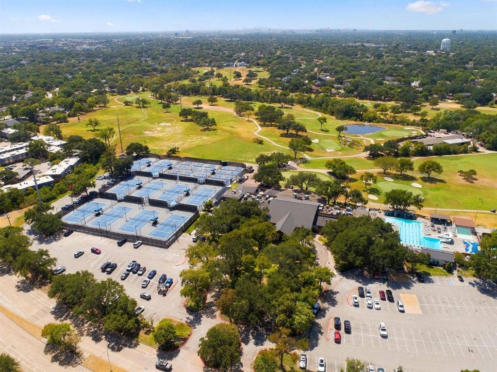 46 Crown Place, Richardson, TX 75080 Expansive golf course with multiple greens, serene pond feature, numerous tennis courts, and a large outdoor swimming pool with dedicated lap lanes
