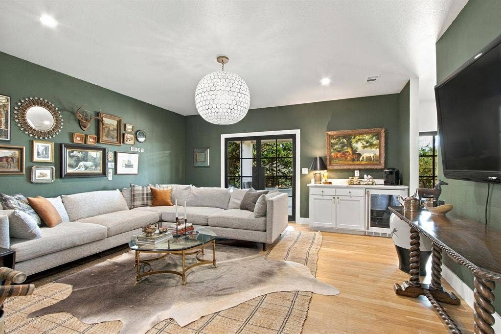 46 Crown Place, Richardson, TX 75080 Recessed lighting, wood-finish flooring, and a decorative ceiling fixture illuminate the space