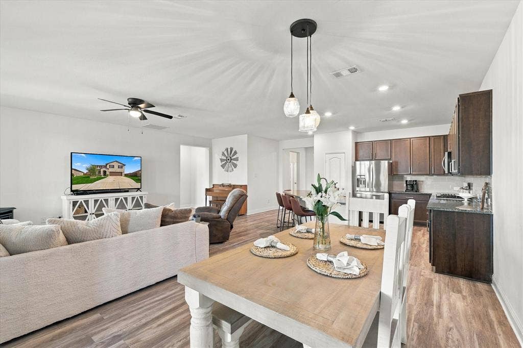 Large open area with dining room, living room, and kitchen with oversized island which provides a lot of additional seating