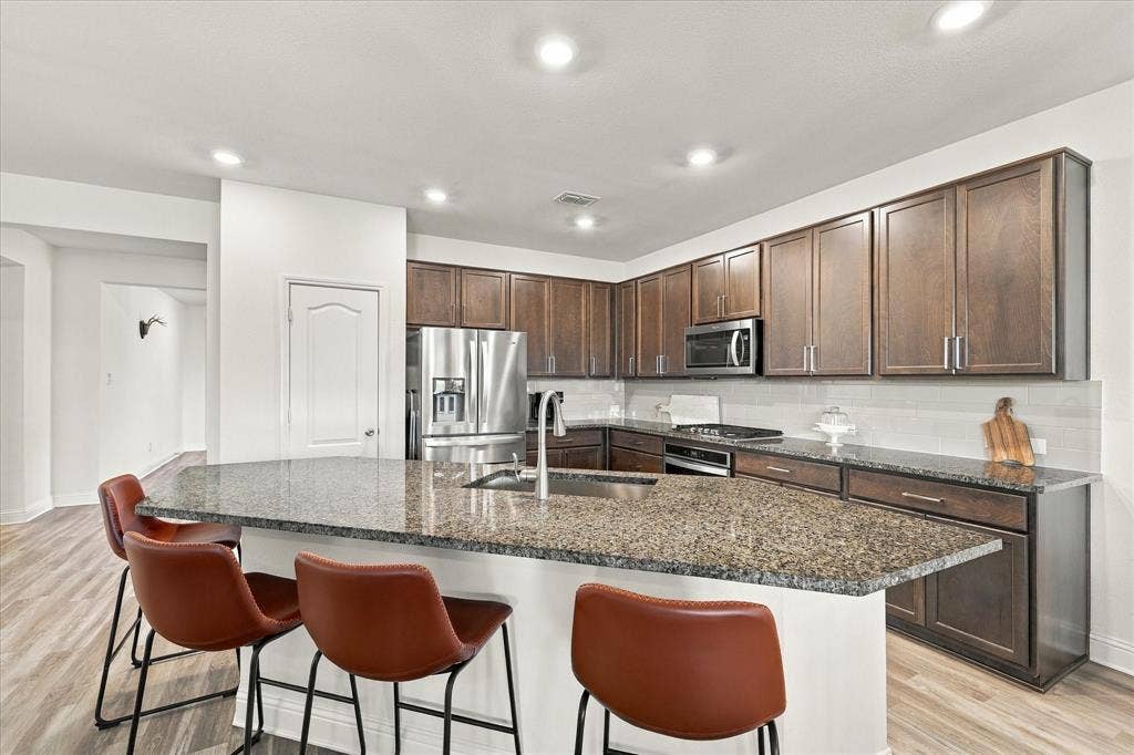Kitchen with lots of cabinet space and oversized island providing additional seating