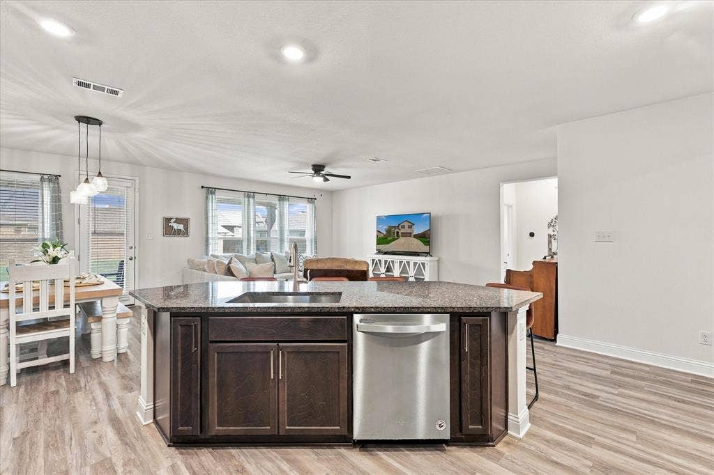 Large open area with dining room, living room, and kitchen with oversized island which provides a lot of additional seating