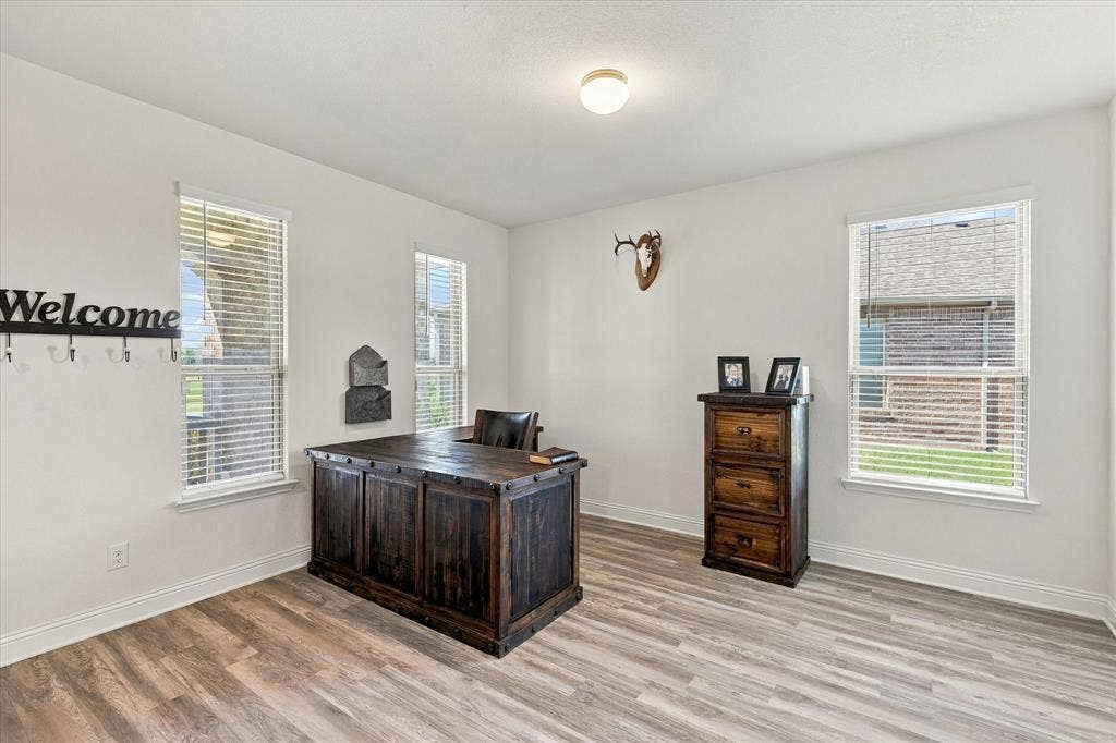 Front room currently being used as an office, but could be a dining area, second living room, or many other options.
