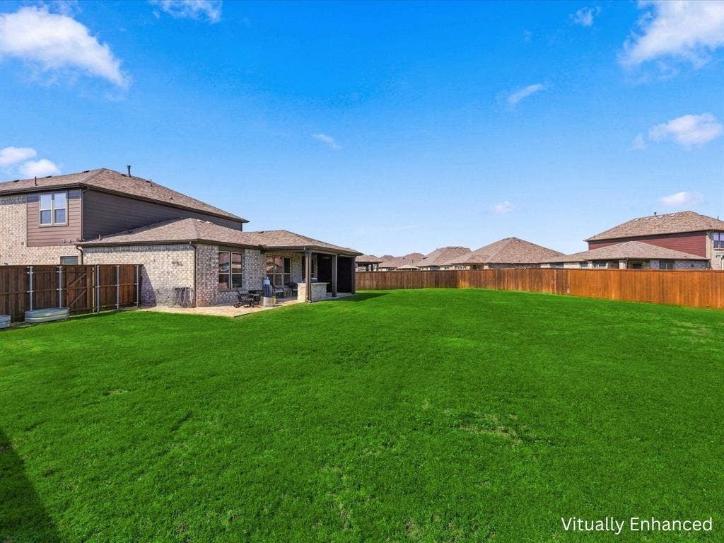Oversized backyard showing back patio entertaining area.