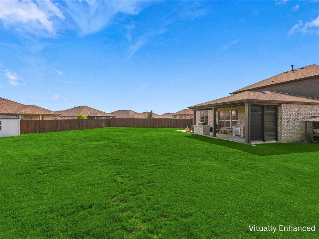 Oversized backyard showing back patio entertaining area and storage building.