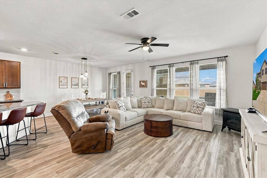 Large open area with dining room, living room, and kitchen with oversized island which provides a lot of additional seating