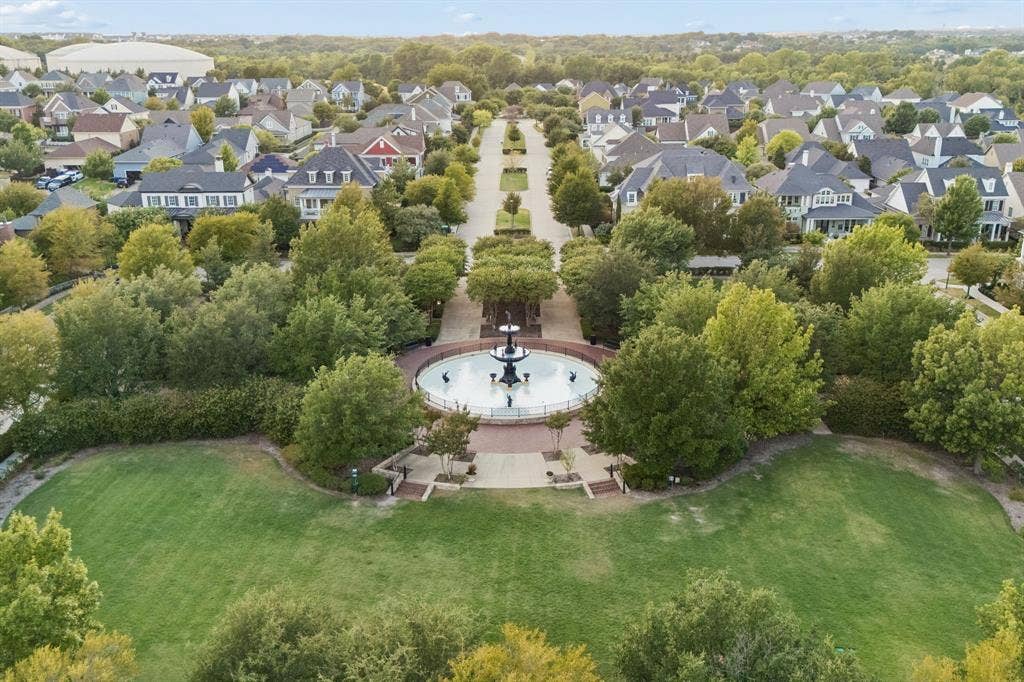 2221 Tremont Boulevard, McKinney, TX 75071 Expansive green space featuring a central fountain, paved walkways, and mature trees