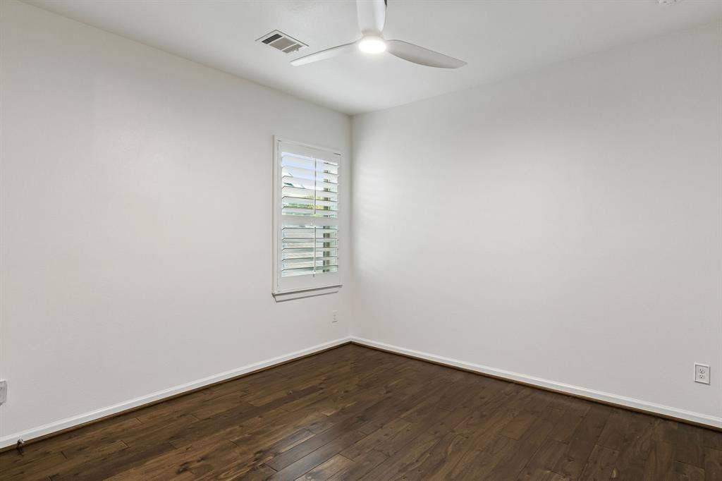 2221 Tremont Boulevard, McKinney, TX 75071 Wood-finish flooring, white walls, window with plantation shutters, and a ceiling fan with integrated lighting