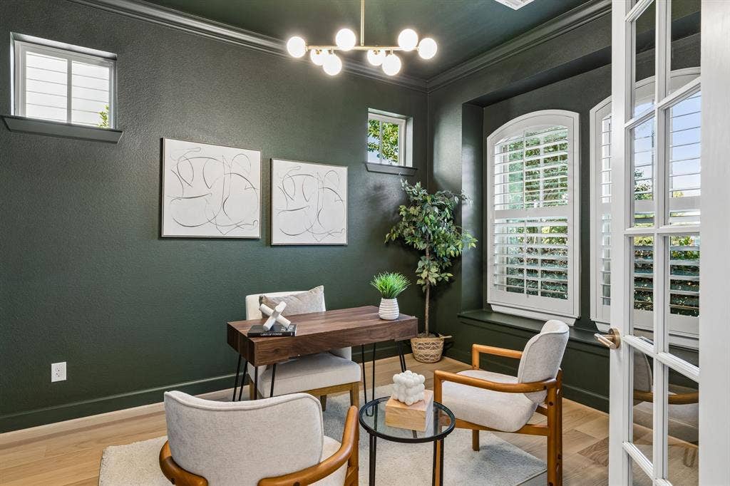2221 Tremont Boulevard, McKinney, TX 75071 Dark green walls with crown molding, light wood-finish flooring, French doors with glass panes, transom windows, and arched windows with plantation shutters