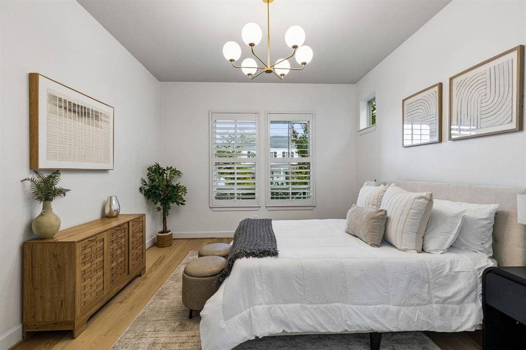 2221 Tremont Boulevard, McKinney, TX 75071 Hardwood-finish flooring, white walls, and a contemporary chandelier