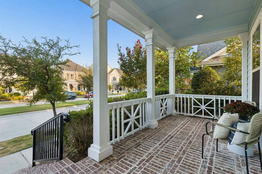 2221 Tremont Boulevard, McKinney, TX 75071 Brick-patterned porch flooring, white column supports, classic railing design, light-colored ceiling, and recessed lighting