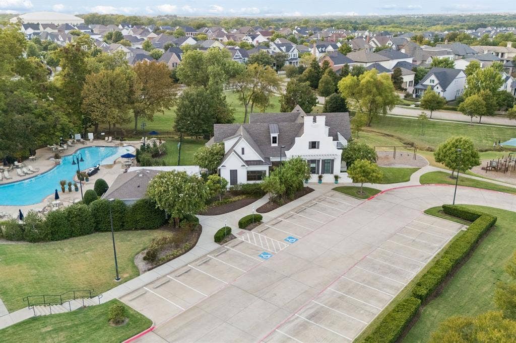 2221 Tremont Boulevard, McKinney, TX 75071 Community building featuring gabled roofs, a swimming pool, and dedicated parking