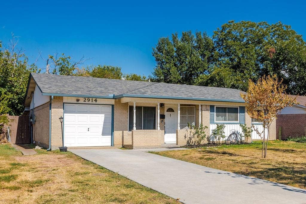 2914 Harvard Street N, Irving, TX 75062 Brick exterior with a gabled roof and attached single-car garage