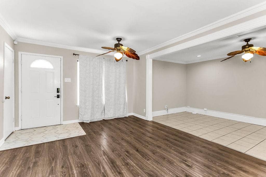 2914 Harvard Street N, Irving, TX 75062 Wood-finish flooring, white trim, and ceiling fans