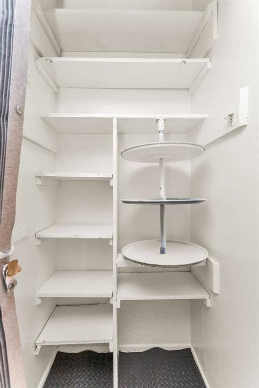 2914 Harvard Street N, Irving, TX 75062 Built-in shelving with a corner lazy Susan unit and diamond-plate pattern flooring