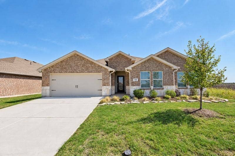 339 Exploration Way, Fate, TX 75189 Brick and stone facade with a gabled roofline