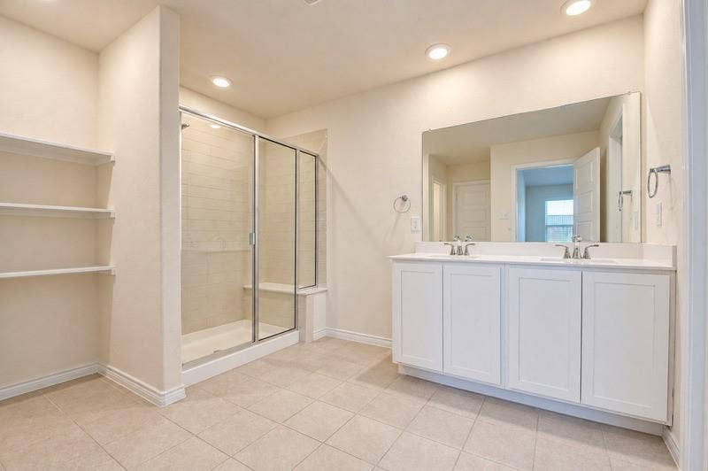 339 Exploration Way, Fate, TX 75189 Dual vanity with undermount sinks, frameless mirror, and white shaker-style cabinetry