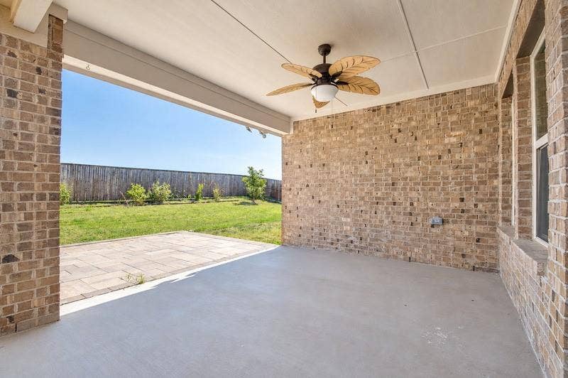 339 Exploration Way, Fate, TX 75189 Covered patio with a ceiling fan, concrete flooring, and brick construction