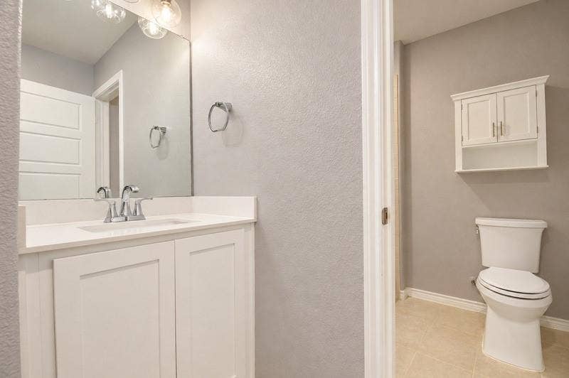 339 Exploration Way, Fate, TX 75189 White vanity with integrated sink, chrome faucet, and overhead lighting