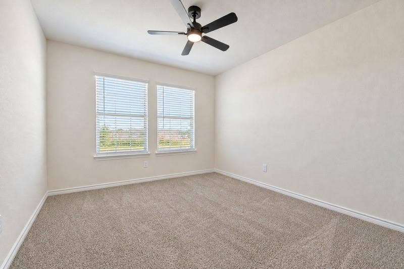 339 Exploration Way, Fate, TX 75189 Spacious room featuring neutral carpet flooring, two windows with blinds, a ceiling fan with integrated lighting, and light-toned walls