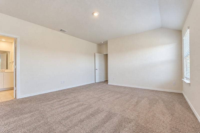 339 Exploration Way, Fate, TX 75189 Vaulted ceiling, recessed lighting, neutral tone carpeting, window with blinds, and white interior doors