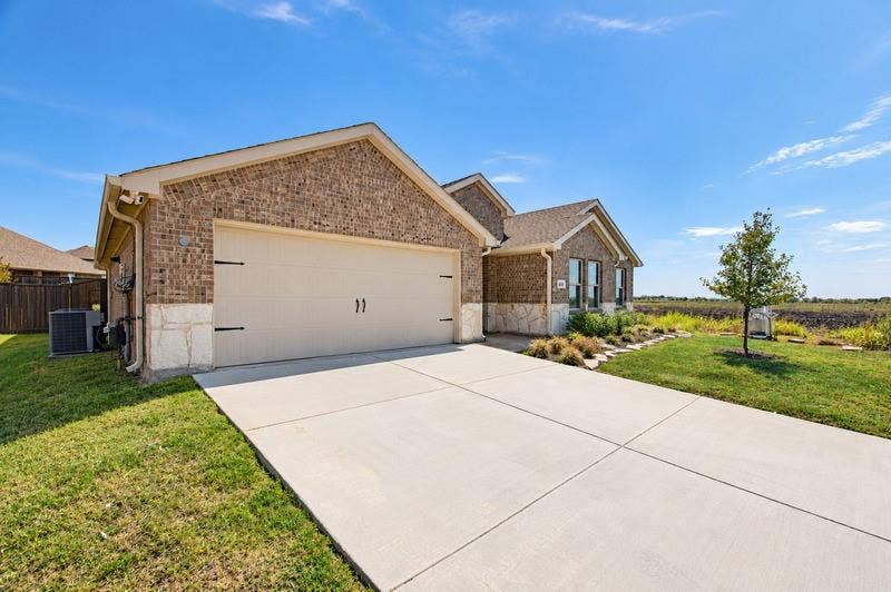 339 Exploration Way, Fate, TX 75189 Brick and stone veneer exterior with a two-car garage