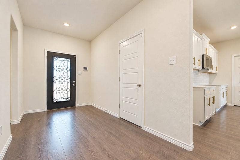 339 Exploration Way, Fate, TX 75189 Wood-finish flooring, recessed lighting, and a decorative glass-paneled entry door