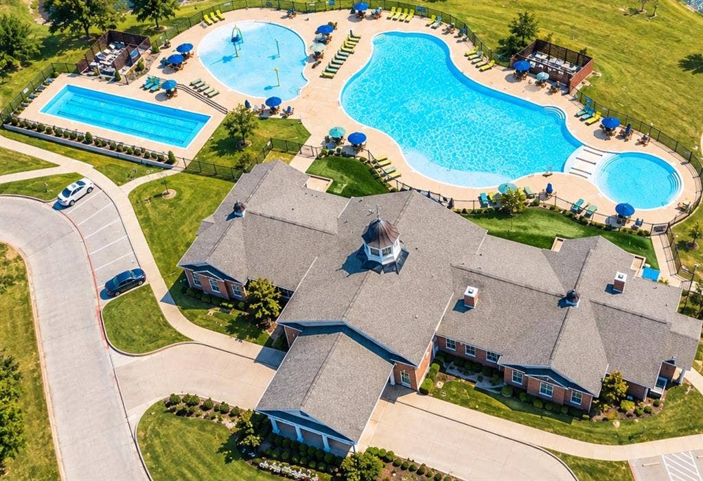 339 Exploration Way, Fate, TX 75189 Community building with a cupola, two distinct swimming pools, an adjacent spa, and a separate rectangular lap pool