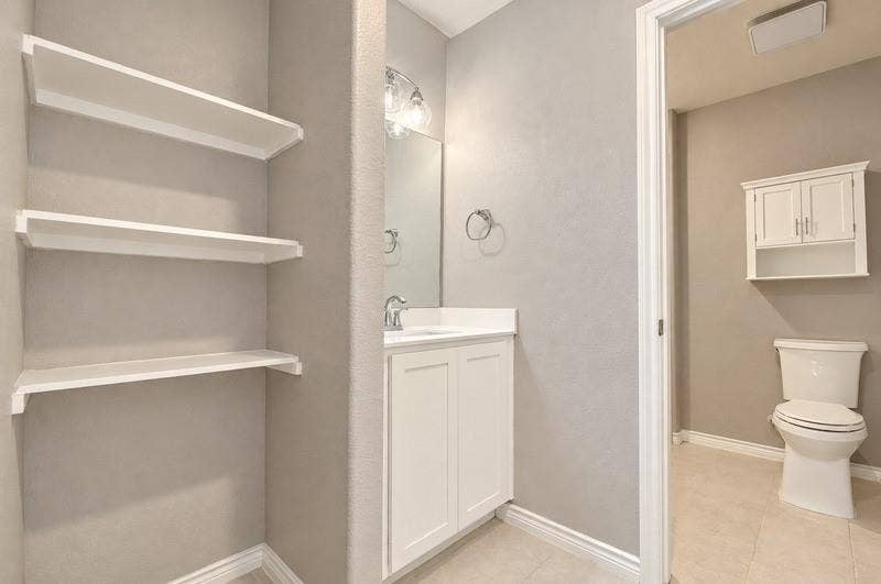 339 Exploration Way, Fate, TX 75189 Vanity with single-basin sink, wall-mounted mirror, and overhead light fixture