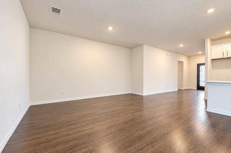 339 Exploration Way, Fate, TX 75189 Spacious room featuring wood-finish flooring, recessed lighting, and crisp white walls