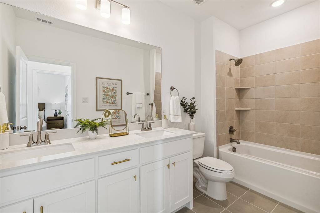 9735 Speaker Drive, Frisco, TX 75035 Friends and family will feel right at home in this thoughtfully designed, beautifully finished guest bath.