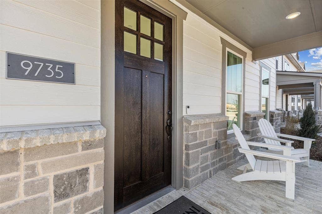 9735 Speaker Drive, Frisco, TX 75035 The stone and brick facade with Craftsman front door welcomes friends and family into your new dream home!