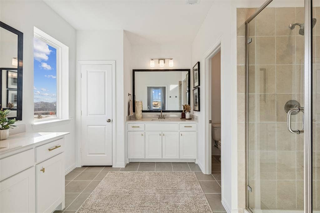 9735 Speaker Drive, Frisco, TX 75035 Featuring his and her vanities, this lovely owner's suite has ample room for two!