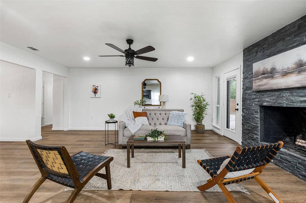 1132 Western Oaks Drive, Woodway, TX 76712 Spacious living area featuring wood-finish flooring, a stacked stone fireplace, recessed lighting, and a ceiling fan