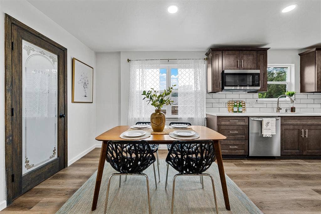 1132 Western Oaks Drive, Woodway, TX 76712 Kitchen featuring wood-finish cabinetry, stainless steel appliances, a subway tile backsplash, and light-toned countertops