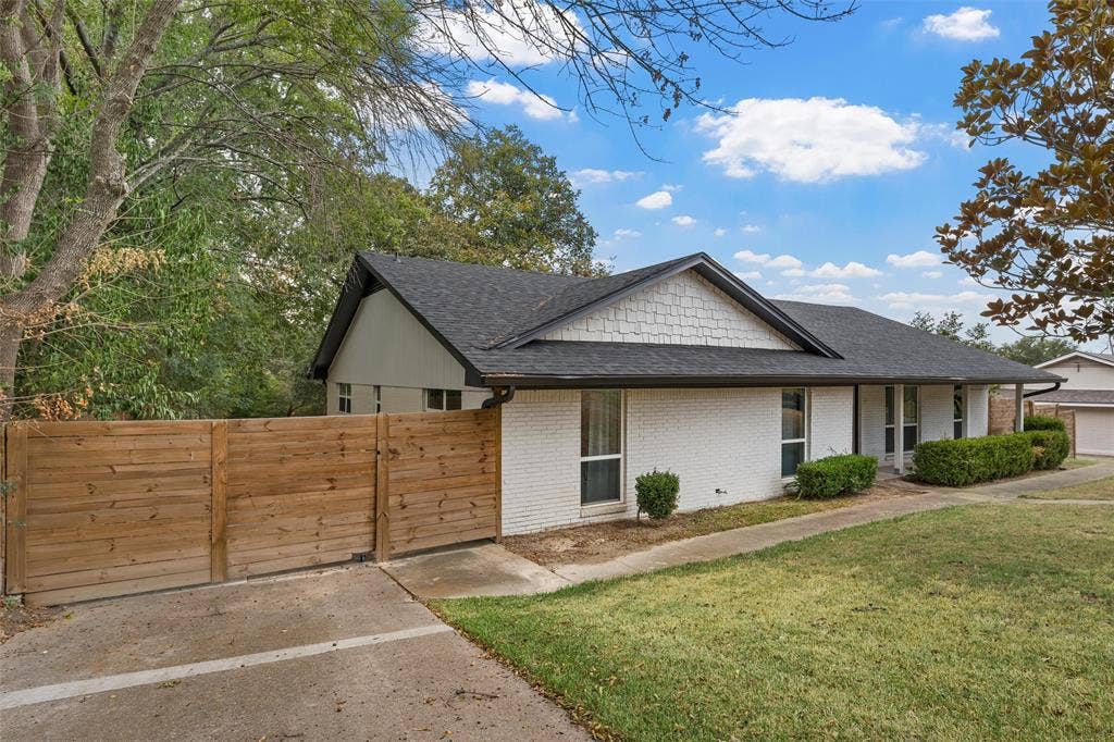 1132 Western Oaks Drive, Woodway, TX 76712 White brick exterior with a dark asphalt shingle roof