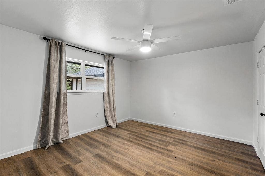 1132 Western Oaks Drive, Woodway, TX 76712 Wood-finish flooring, white walls, and a ceiling fan with integrated lighting