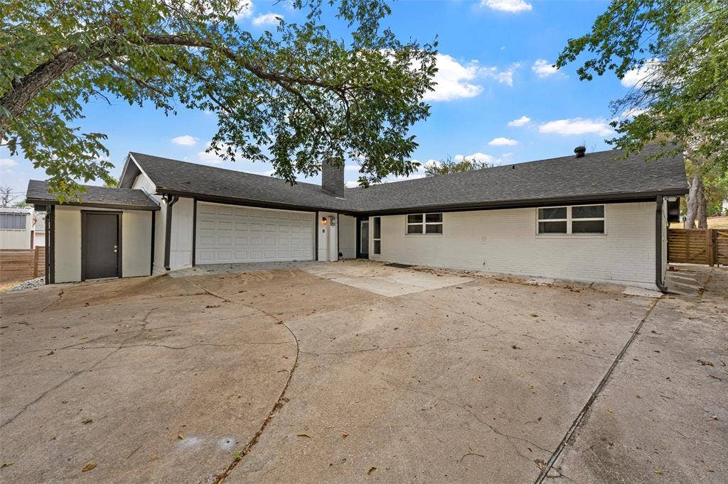 1132 Western Oaks Drive, Woodway, TX 76712 Single-story residence featuring a two-car garage, white painted brick exterior, and a dark shingle roof