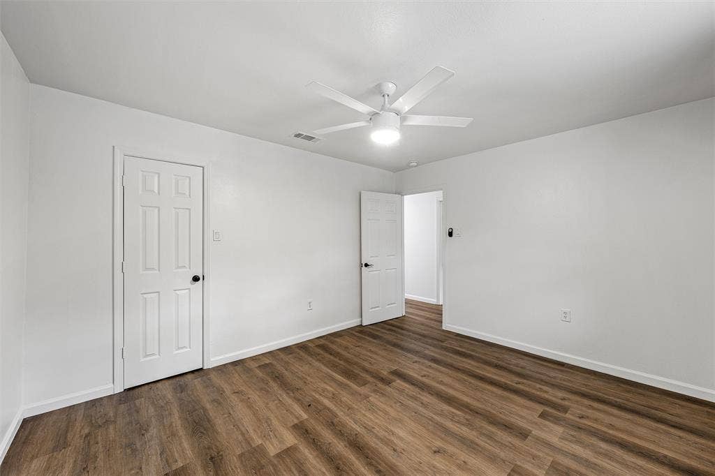 1132 Western Oaks Drive, Woodway, TX 76712 Wood-finish flooring with crisp white walls and white trim